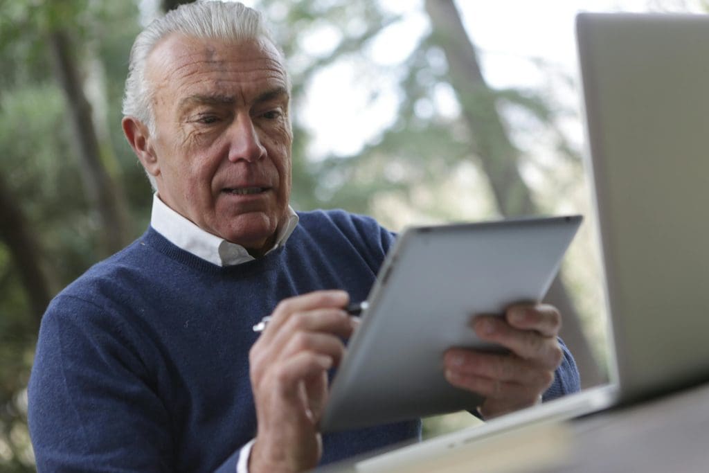 man reading his tablet