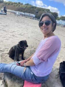 woman on a beach with a dog