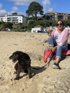 lady and dog on a beach